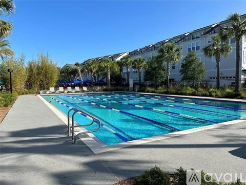 A swimming pool with blue water and a diving board.