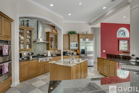 A kitchen with wooden cabinets and a central island.