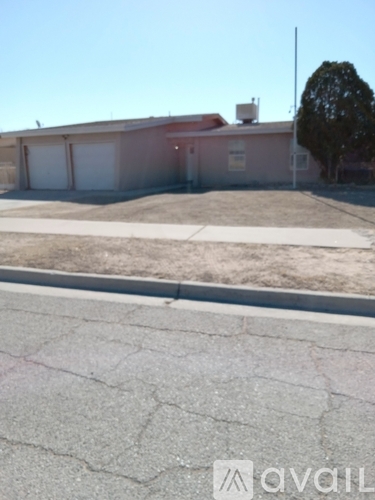 A house with a brown roof and white garage doors is for sale.