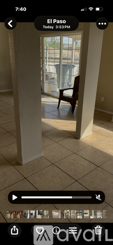 A chair is placed in a room with a view of a balcony.