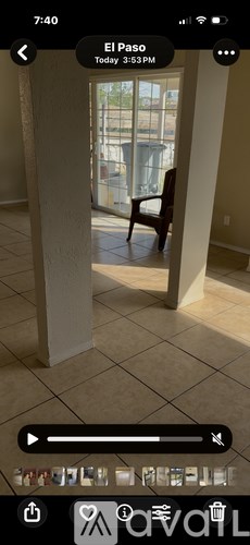 A chair is placed in a room with a view of a balcony.