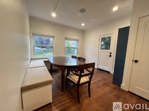 A dining room with a table and chairs.