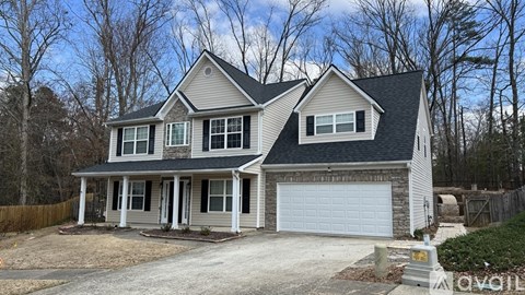 A two-story house with a garage is for sale.