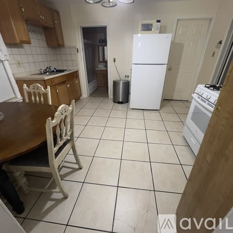 A kitchen with a white fridge and white oven.