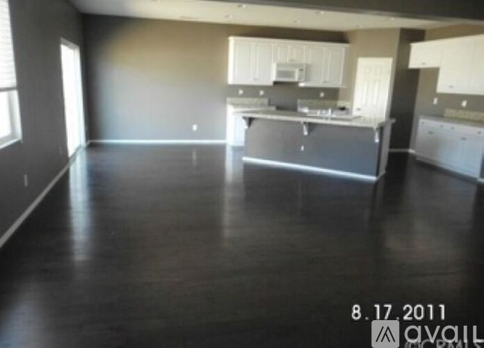 A room with a kitchen area and a dining table.