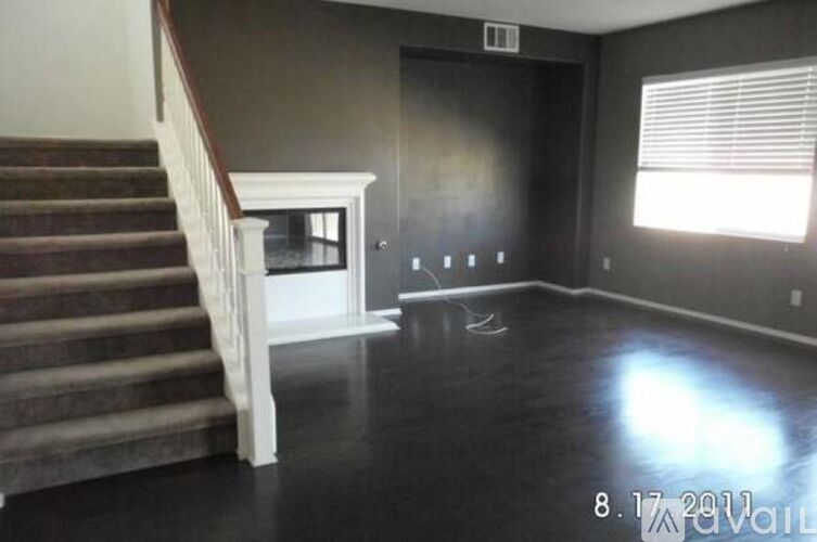 A room with a staircase and a window.