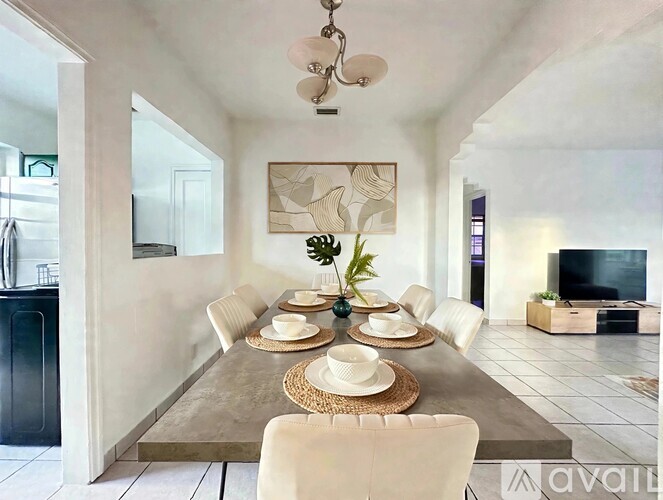 A dining room with a table set for a meal.