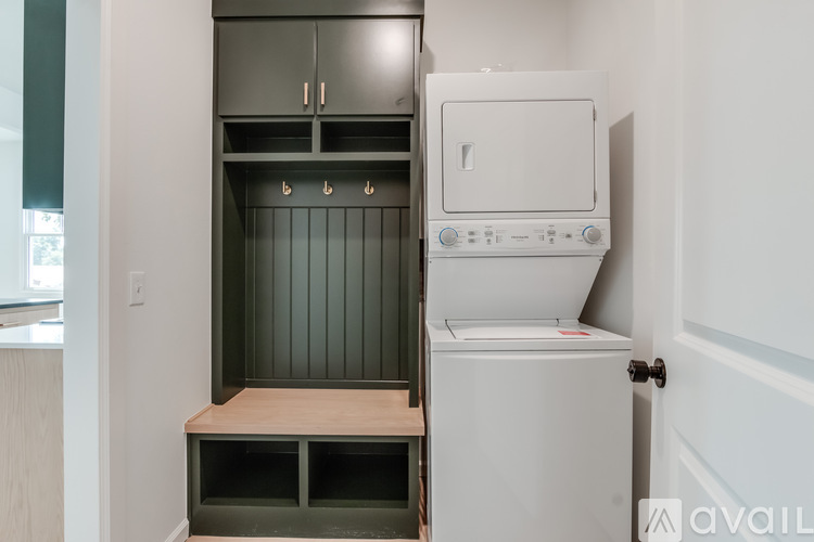 A white oven is in a kitchen with a grey cabinet.