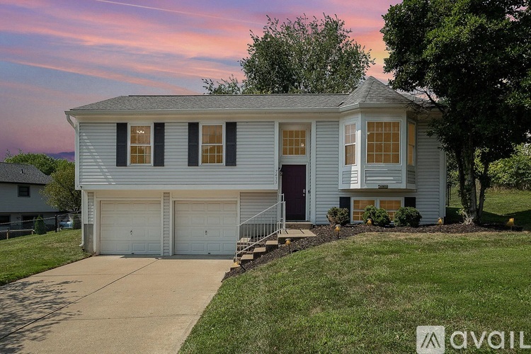 A two-story house with a garage is available for sale.