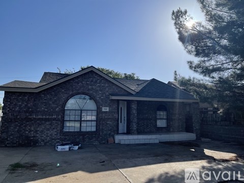 A house with a stone facade and a large arched window is for sale.