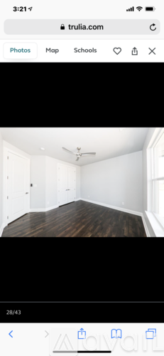 A room with a wooden floor and white walls.