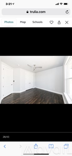 A room with a wooden floor and white walls.