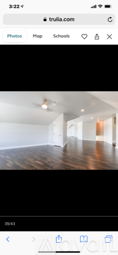 A room with wooden flooring and white walls.
