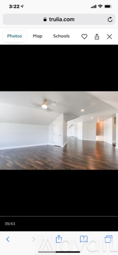 A room with wooden flooring and white walls.