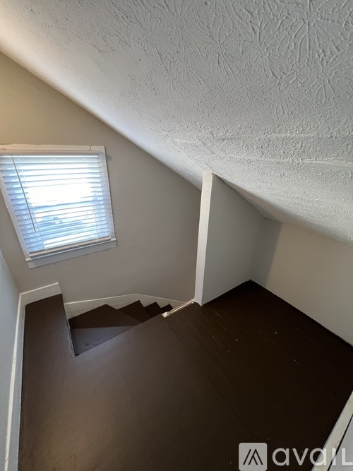 A staircase with a window above it.