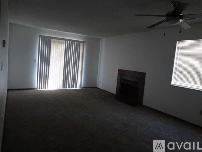 A room with a fireplace and a ceiling fan.