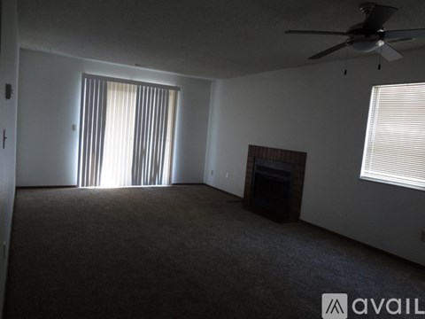 A room with a fireplace and a ceiling fan.