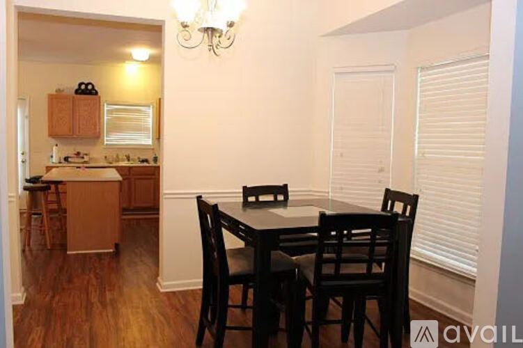 A dining room with a table and chairs is available for rent.