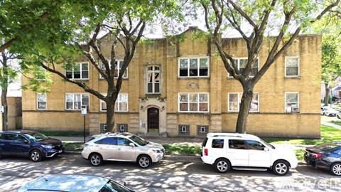 A building with a tree in front of it.