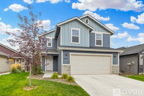 A house with a blue garage door is for sale.