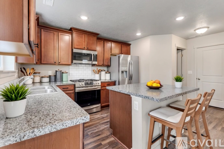 A kitchen with wooden cabinets and granite countertops.