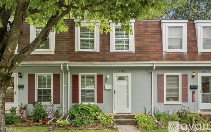 A house with a red and white front porch.