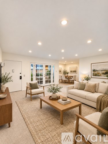 A living room with a couch, chairs, and a coffee table.