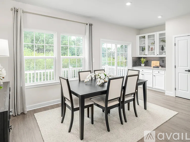 A dining room with a table set for four.