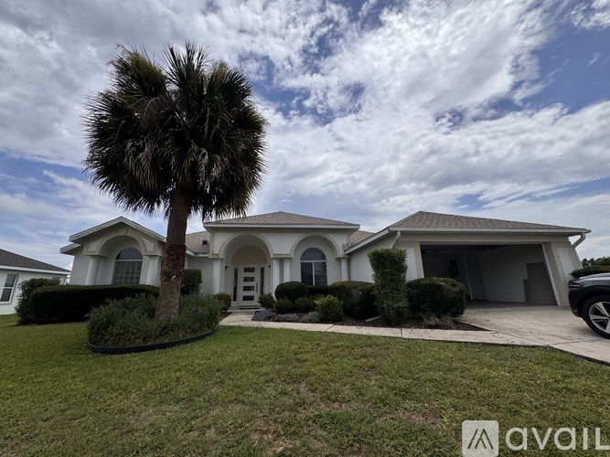 A house with a palm tree in front of it.