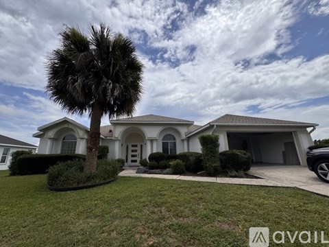 A house with a palm tree in front of it.