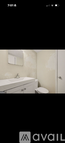 A bathroom with a white bathtub and toilet.