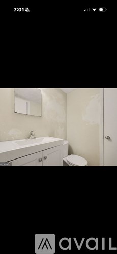 A bathroom with a white bathtub and toilet.