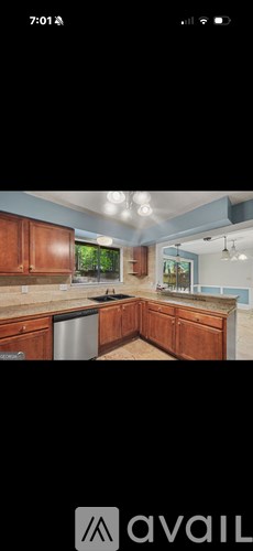 A modern kitchen with wooden cabinets and a large island.