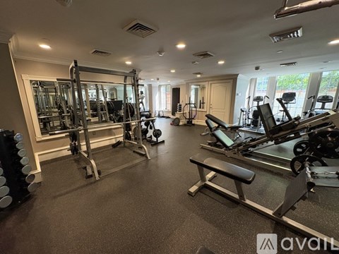 A well-equipped gym with various exercise machines and weights.