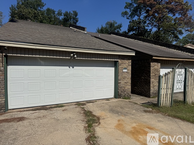 A house with a white garage door is for sale.