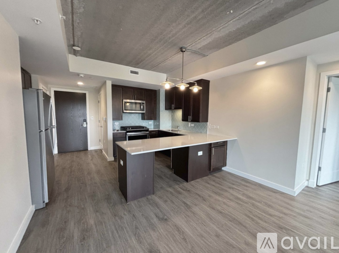 A spacious kitchen with dark wood cabinets and a central island.
