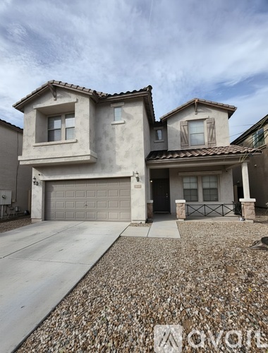 A house with a garage and a driveway in front.