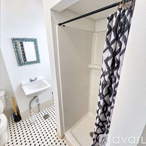 A white bathroom with a black and white checkered floor.