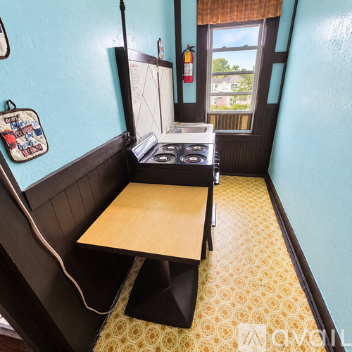 A small kitchen with a stove and a table.
