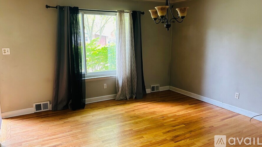 A room with wooden floors and a chandelier.
