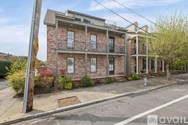 A two-story building with a balcony on the second floor is available for rent.
