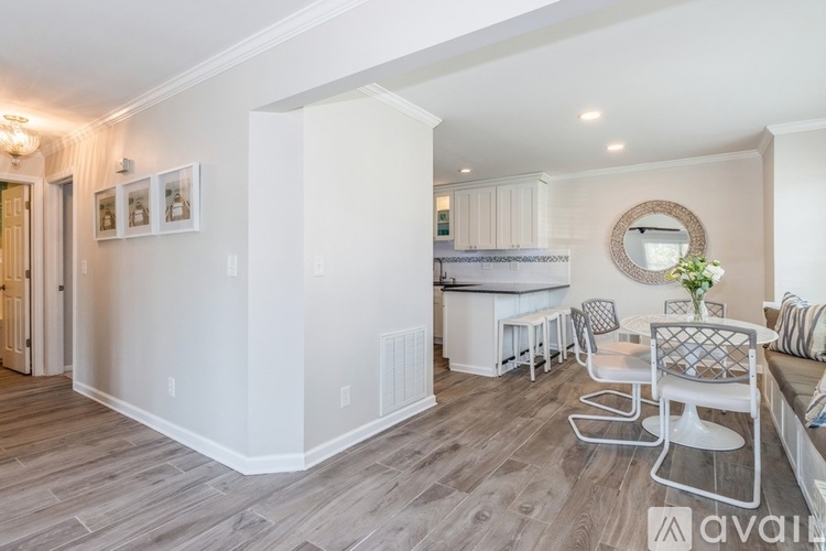 A modern kitchen with a dining table and chairs.