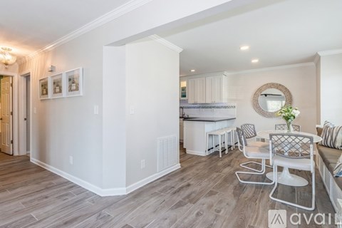 A modern kitchen with a dining table and chairs.