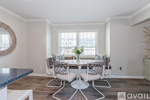 A dining room with a table set for four.