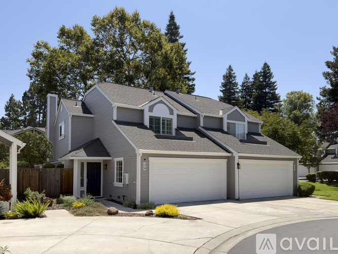 A modern house with a grey exterior and a white garage door.