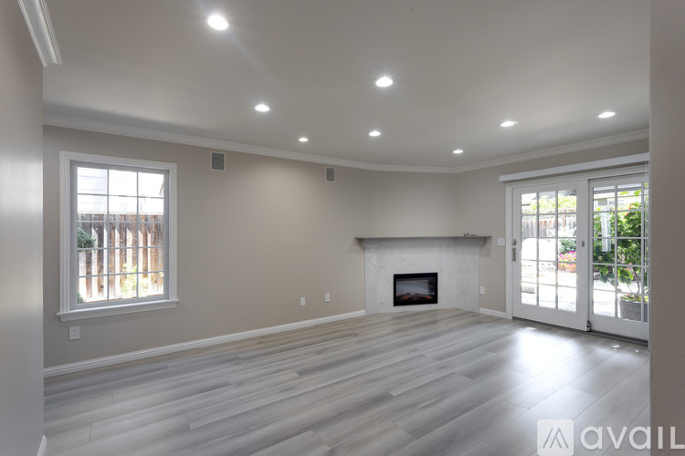 A spacious living room with a fireplace and sliding glass doors.