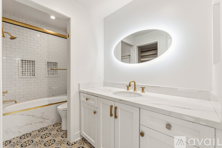 A bathroom with a marble floor and white walls.