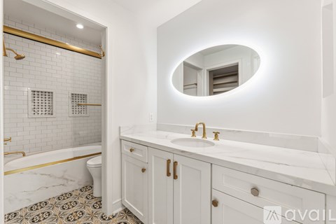 A bathroom with a marble floor and white walls.