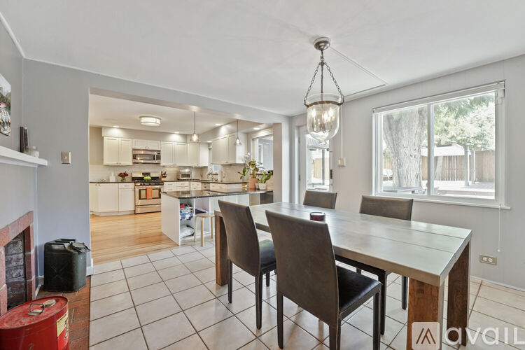 A modern kitchen with a dining table and chairs.