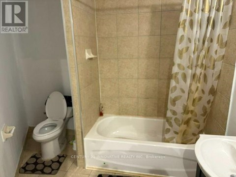A bathroom with a toilet, sink, and bathtub.